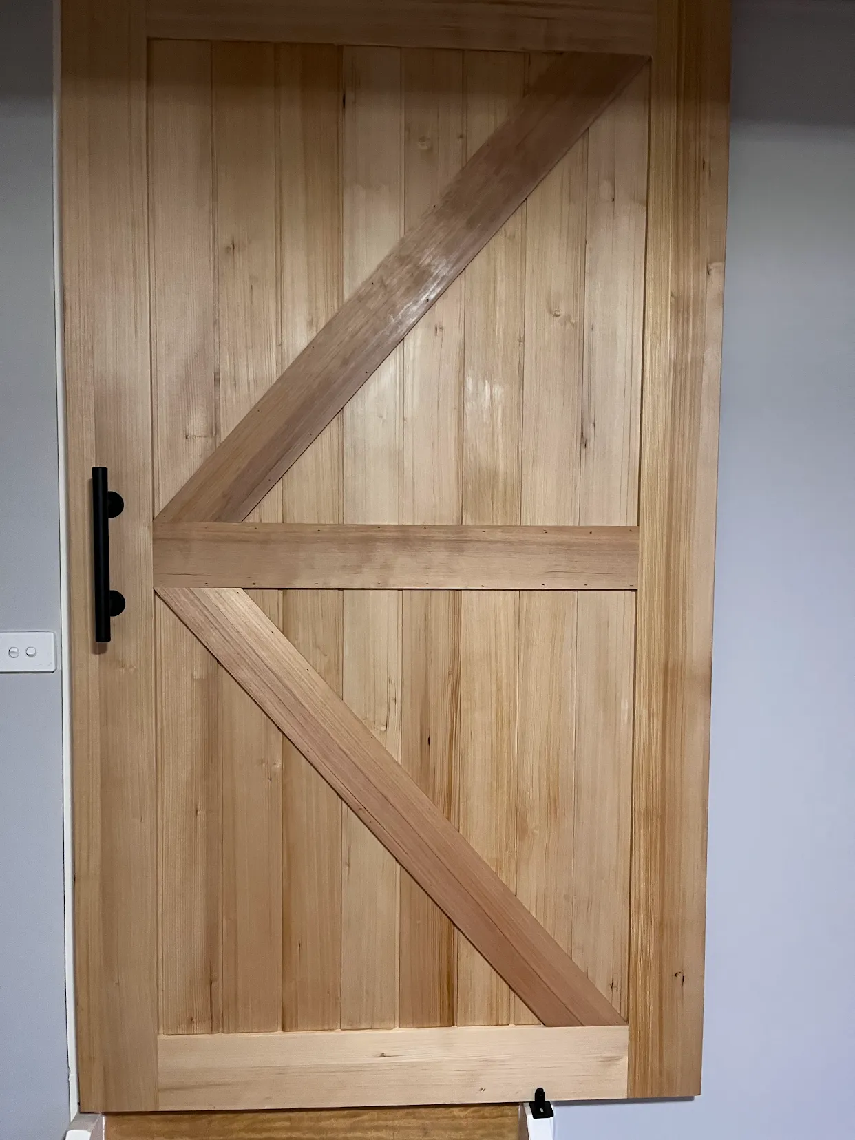 Custom timber barn door with black handle